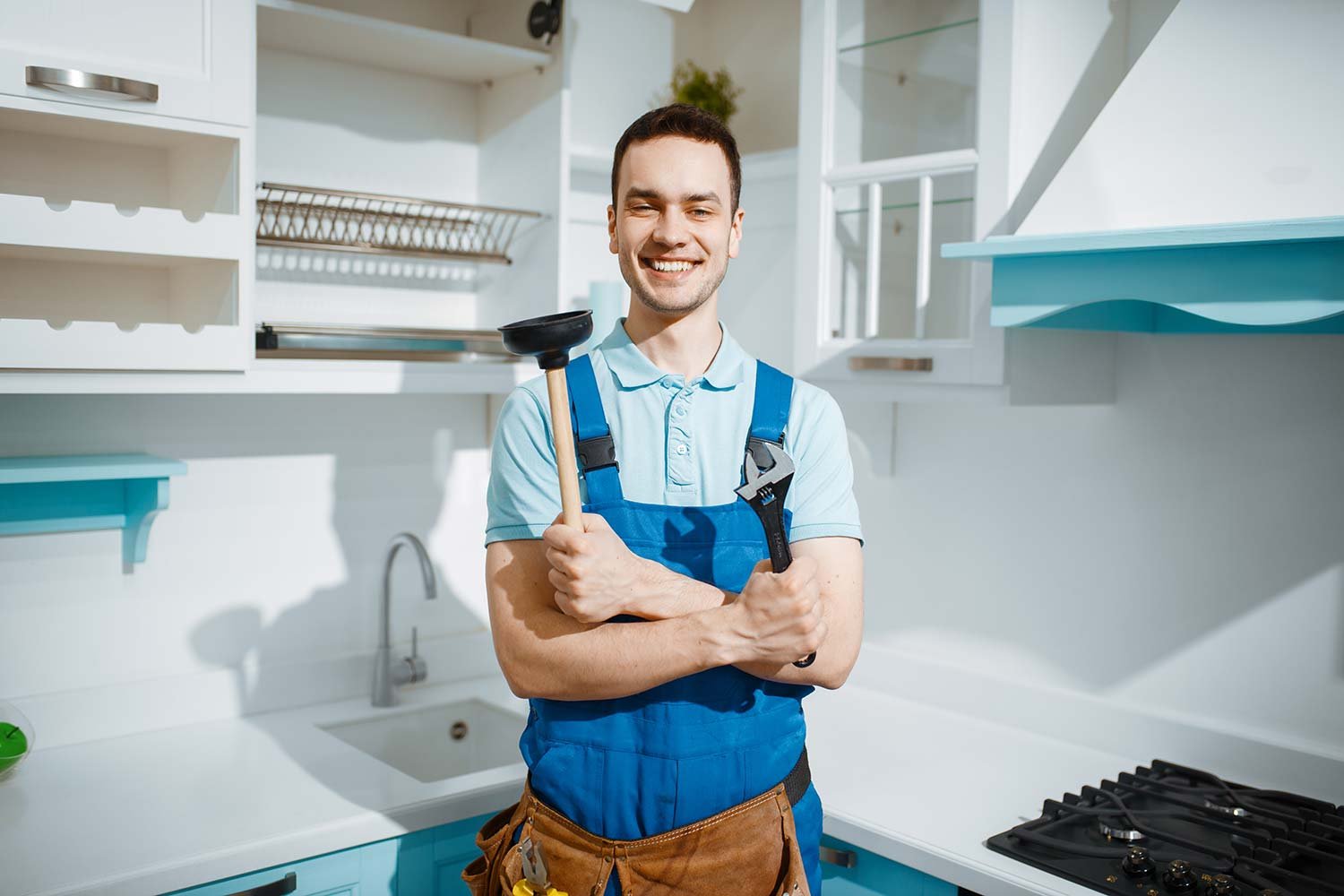 cheerful-male-plumber-holds-wrench-and-plunger-resize.jpg